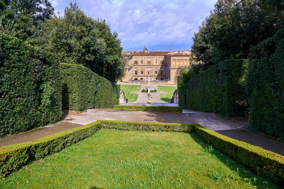 Boboli Gardens with the Pitti Palace behind green lawns and hedges in Florence