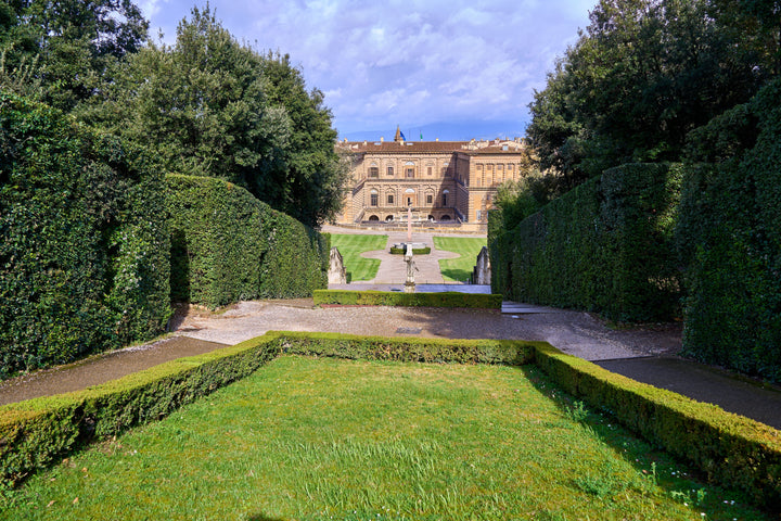 Boboli Gardens with the Pitti Palace behind green lawns and hedges in Florence