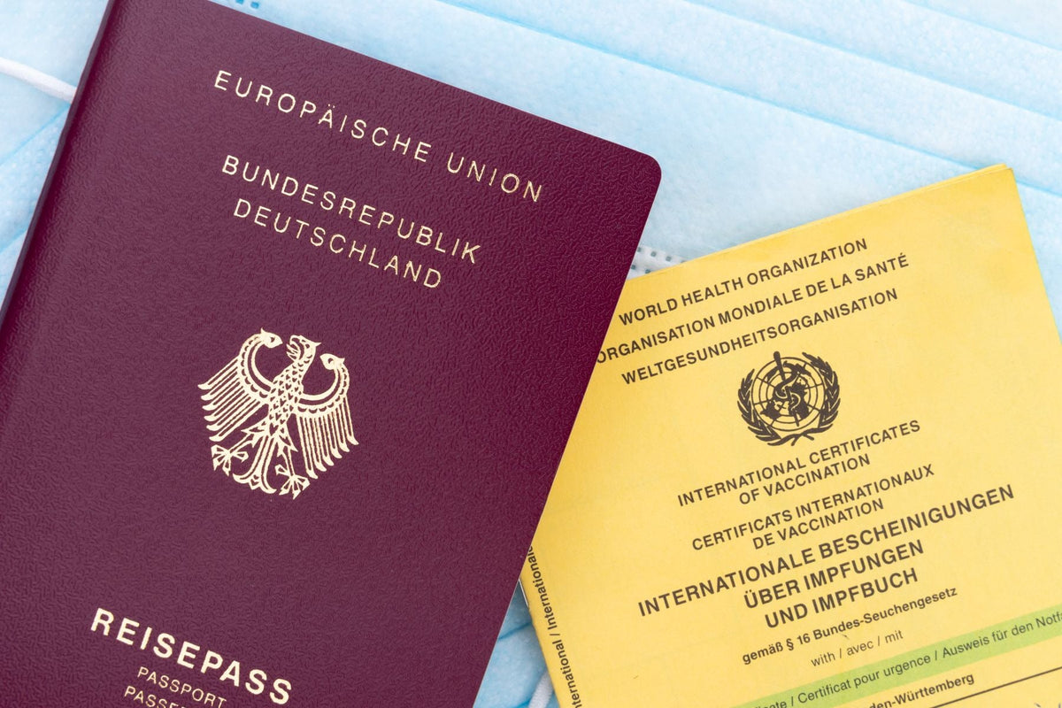 Close-up of a passport and a health card on a table, representing the documents a visitor carries when travelling