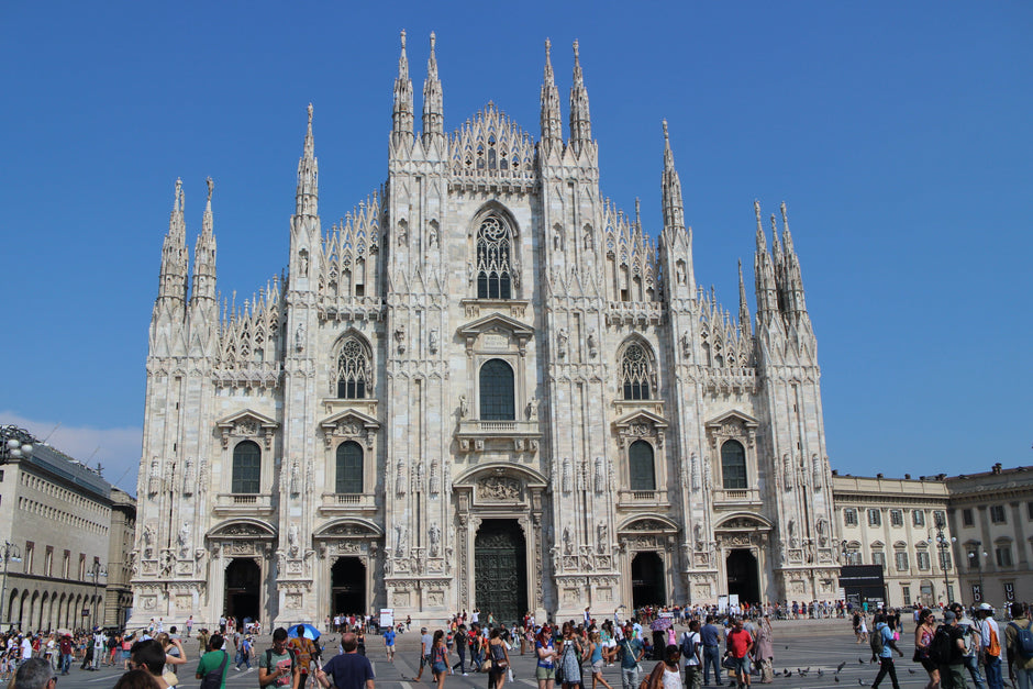 The marble facade and spires of Milan Cathedral from Piazza del Duomo