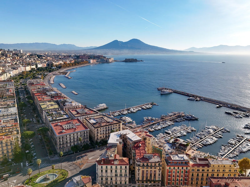 Aerial view of Naples with the dense old city, the bay and Mount Vesuvius in the distance