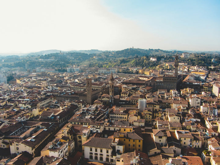 Terracotta roofs of Florence's dense historic centre seen from the Duomo cupola, the area where new short-term rentals are blocked