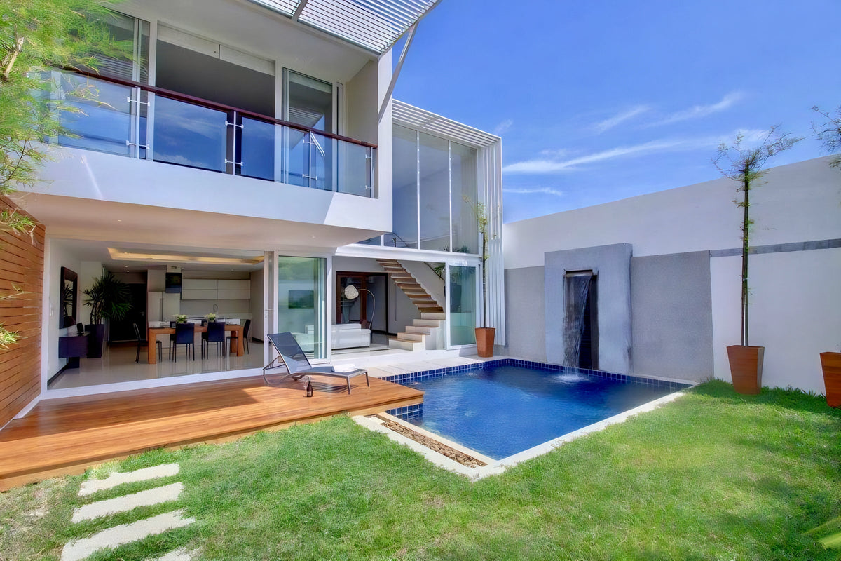 Modern two-storey villa with pool and lawn by Suksan Homes