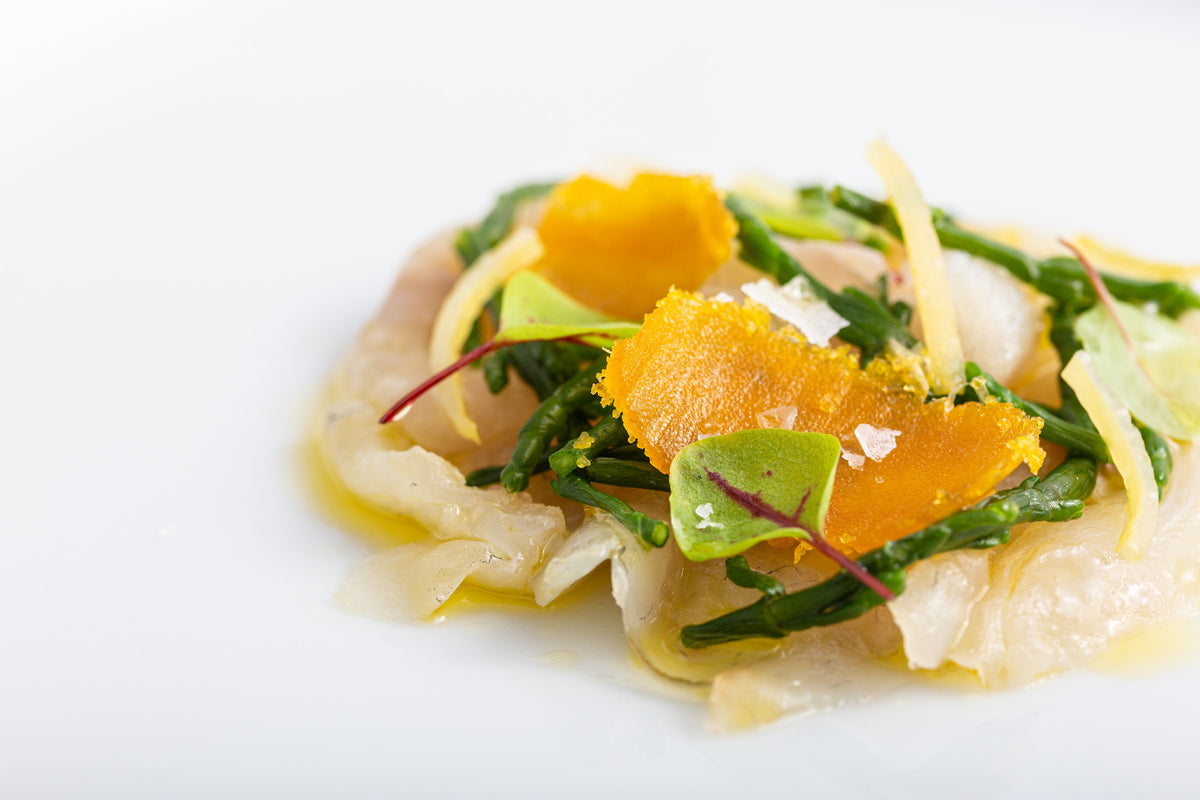 Fish crudo with orange and greens at Comi 107