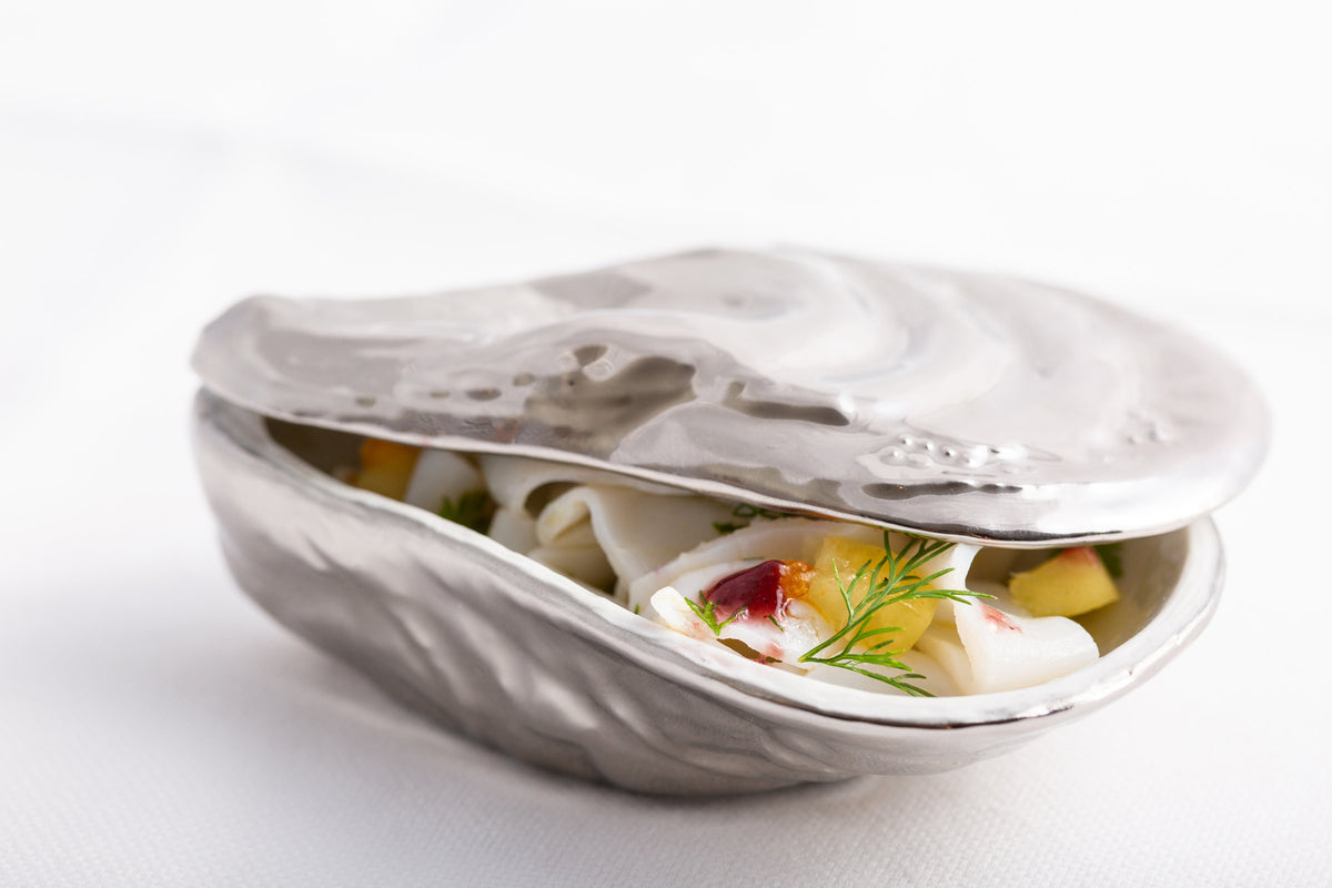 A dish served in a silver shell at Comi 107