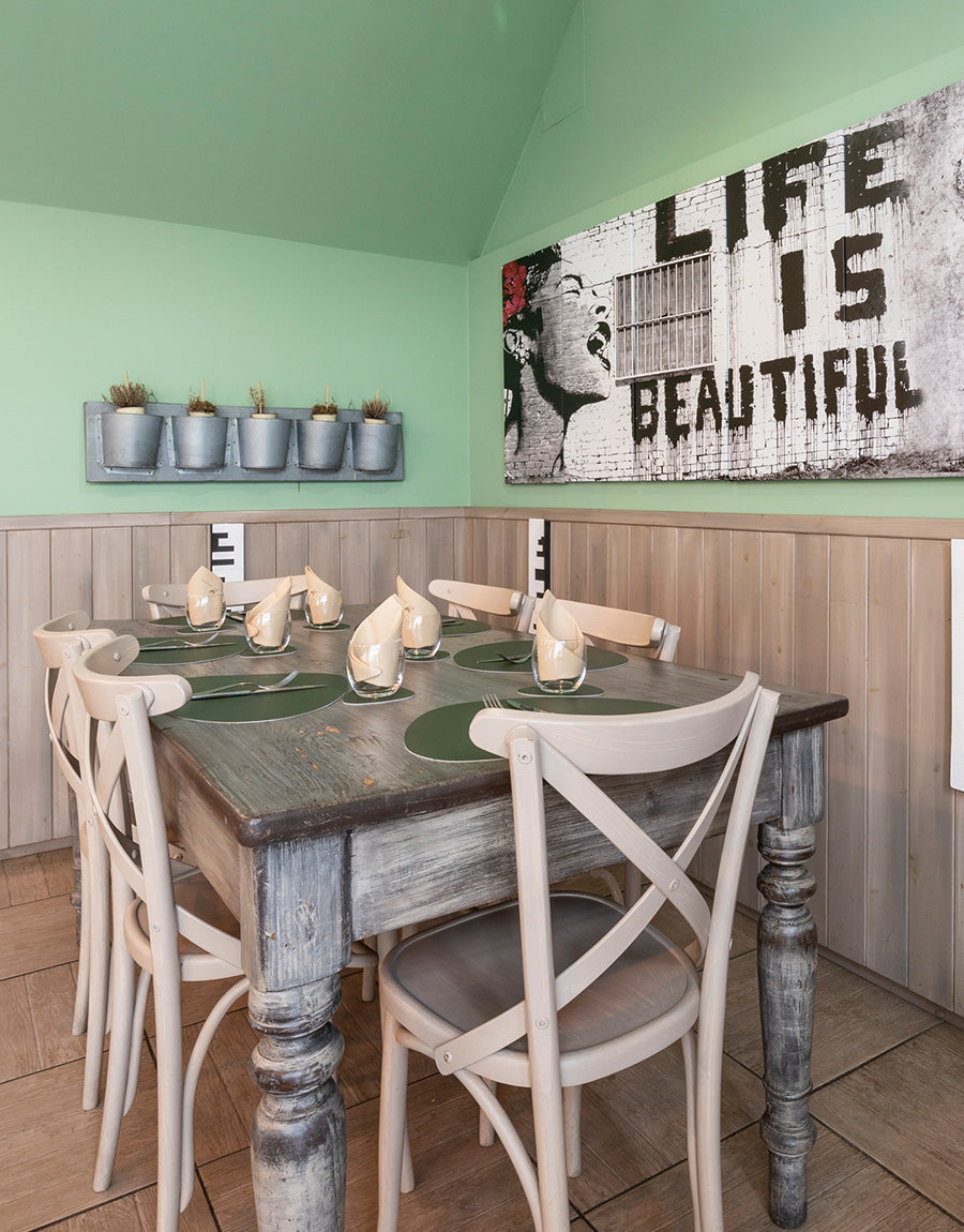 A table under the 'Life is Beautiful' print at Ciàpa Fiaa