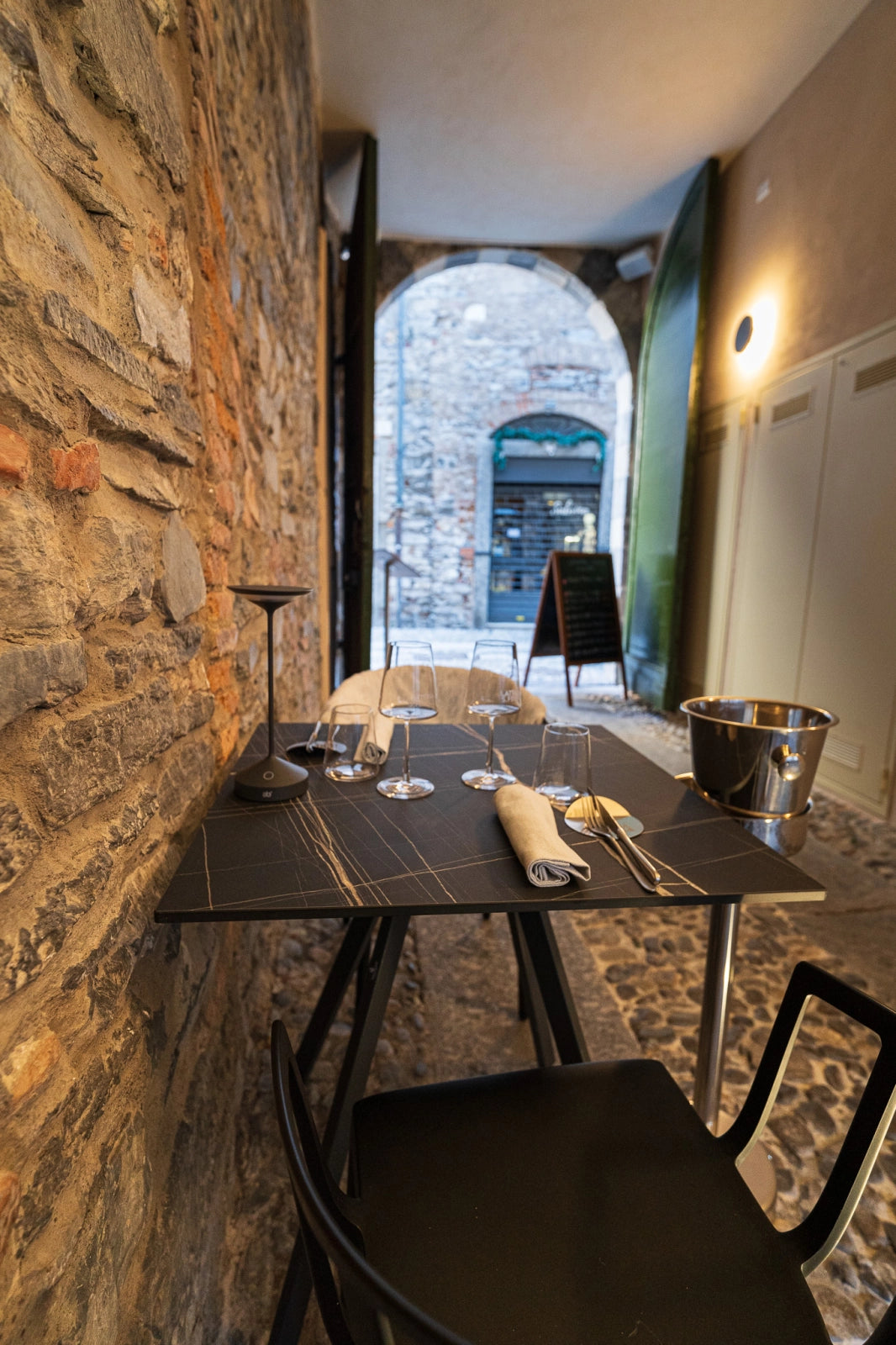 A table in the stone passage at Latteria San Fedele