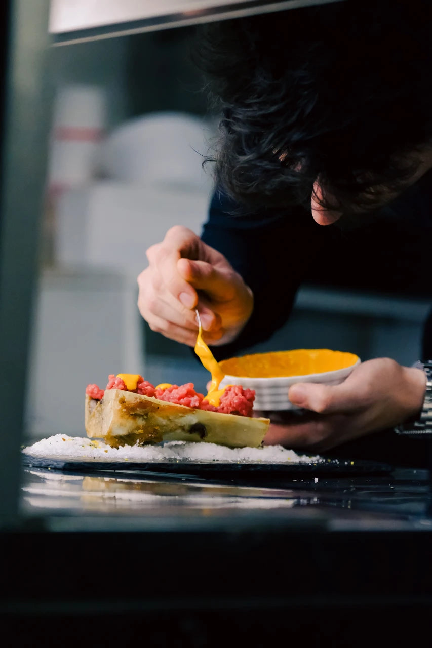 A chef finishing a dish at Latteria San Fedele