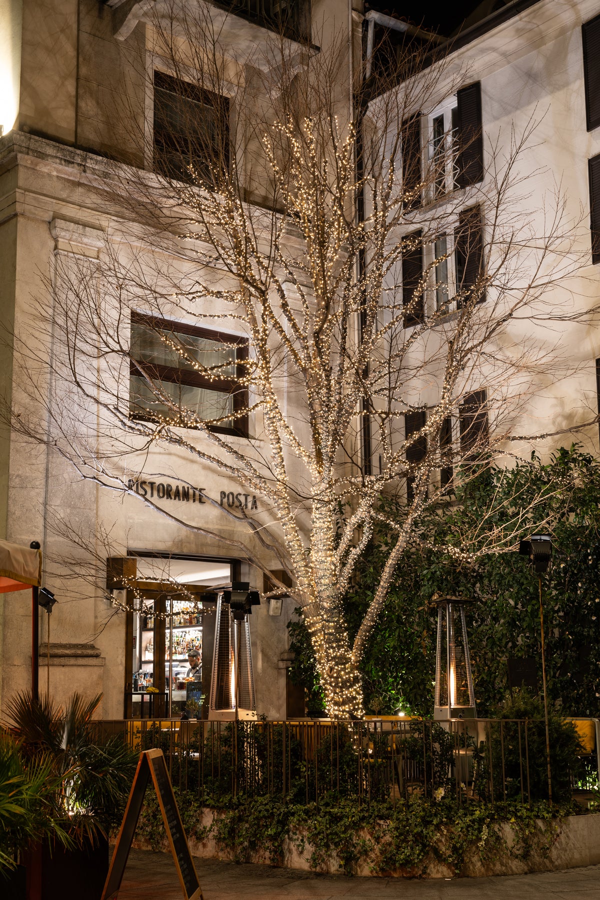 The entrance of Posta Design Hotel by night