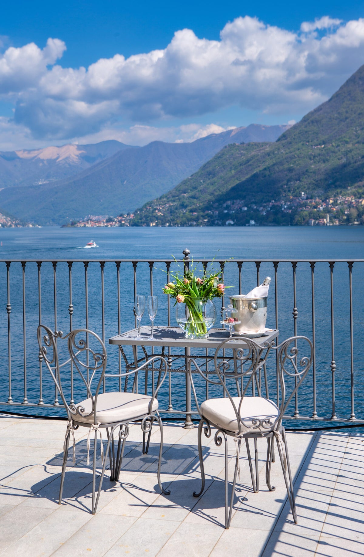 A balcony table above the lake at Hotel Villa Flori
