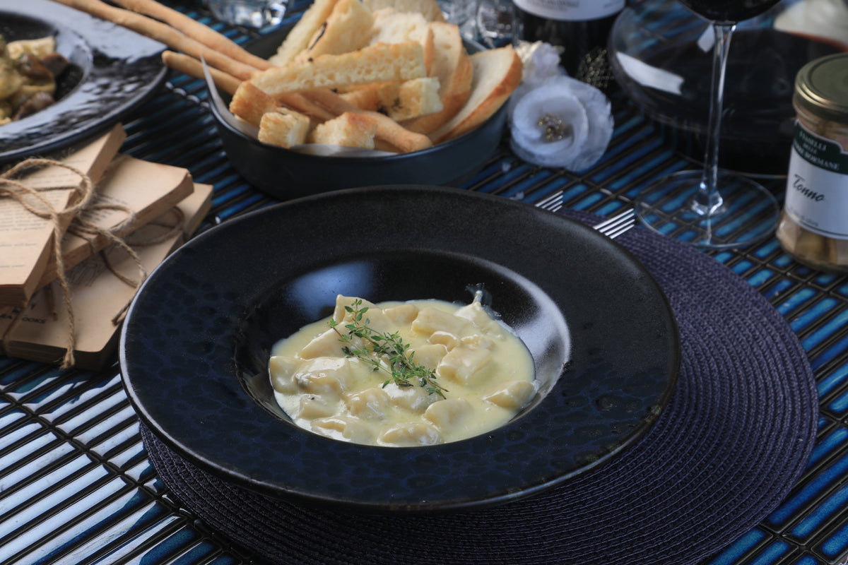 Four-cheese gnocchi served in a dark bowl at That's Amore