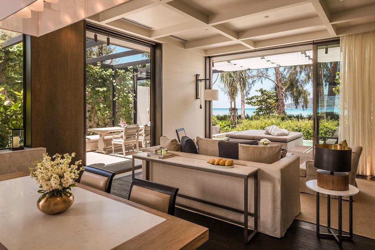 Beachfront pool villa living room opening to the sea at Rosewood Phuket