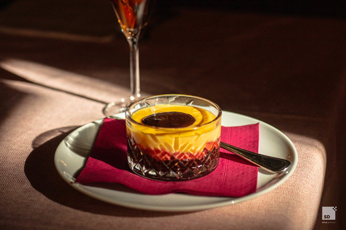 A layered dessert in a cut-glass cup at Al Sangiovese