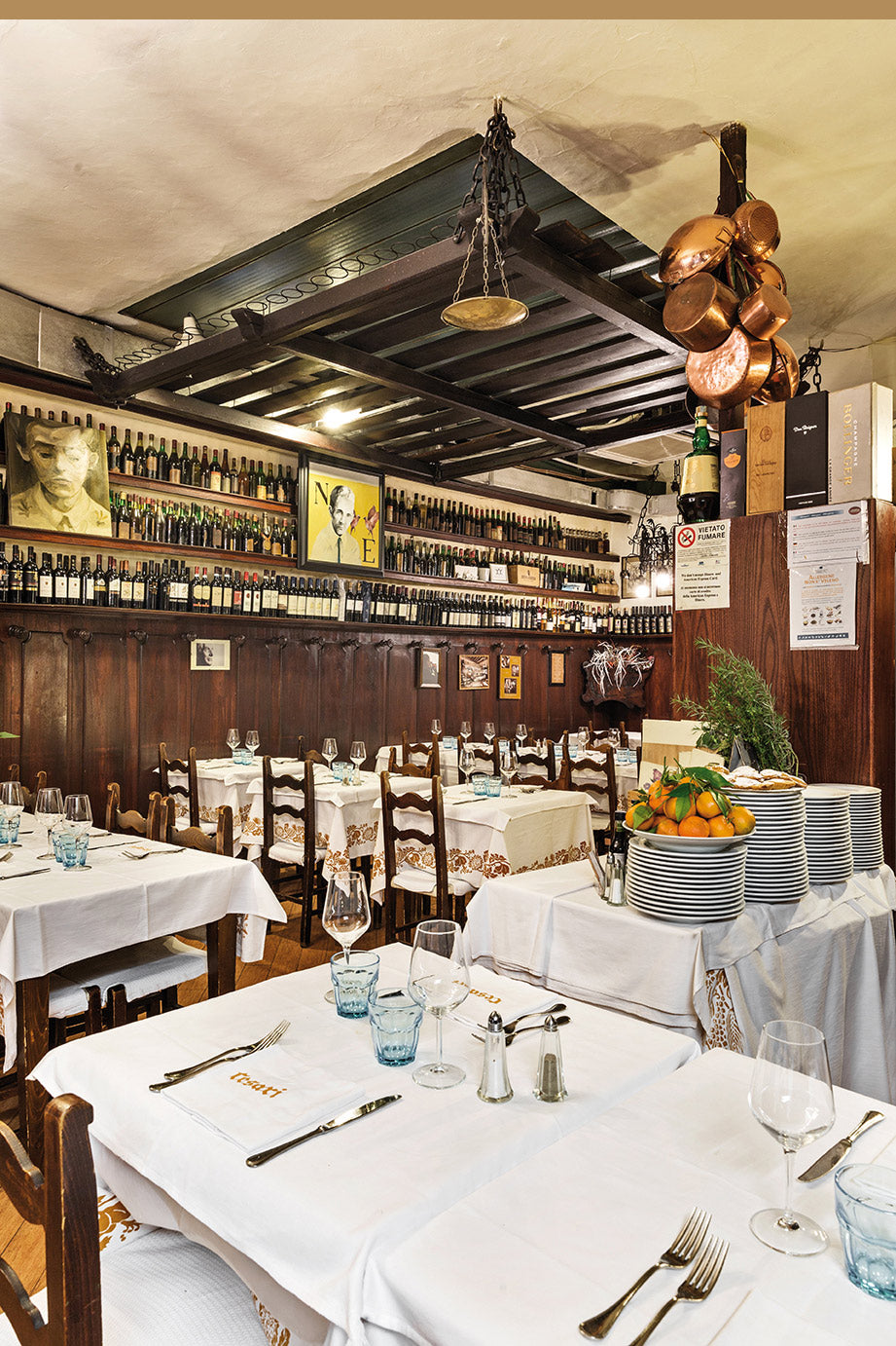 The main dining room with wood panelling and wine shelves at Da Cesari