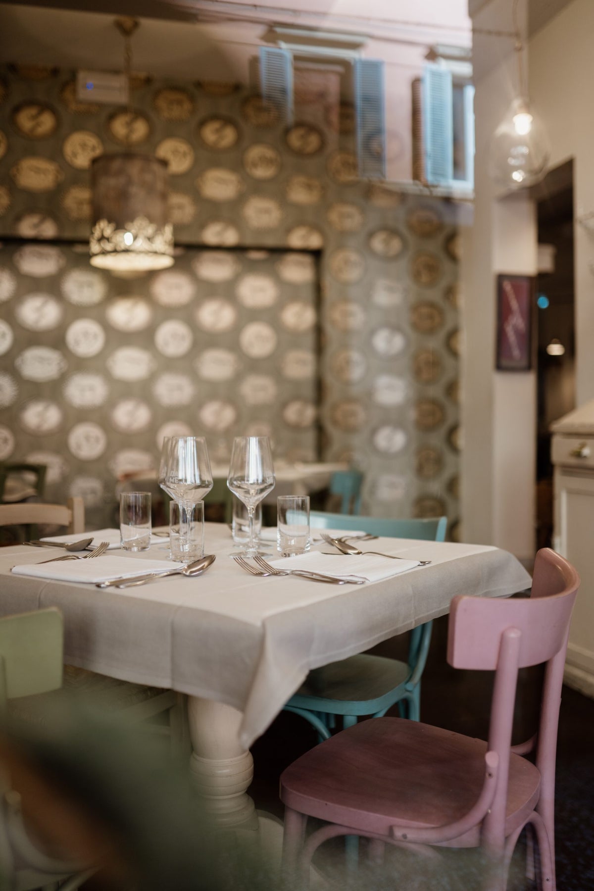 A table set by the patterned wall at Da Me