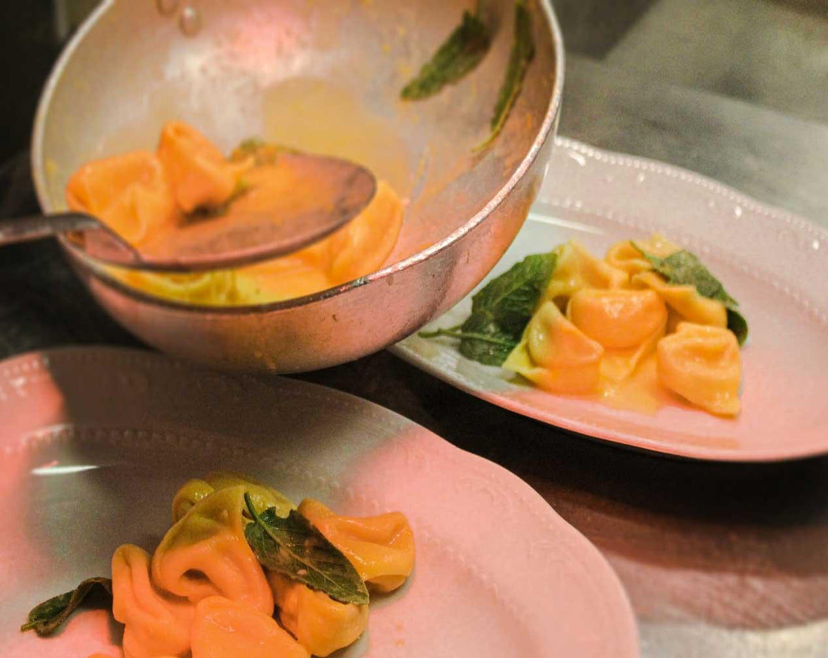 Tortelloni with sage being plated from the pan at Da Nello