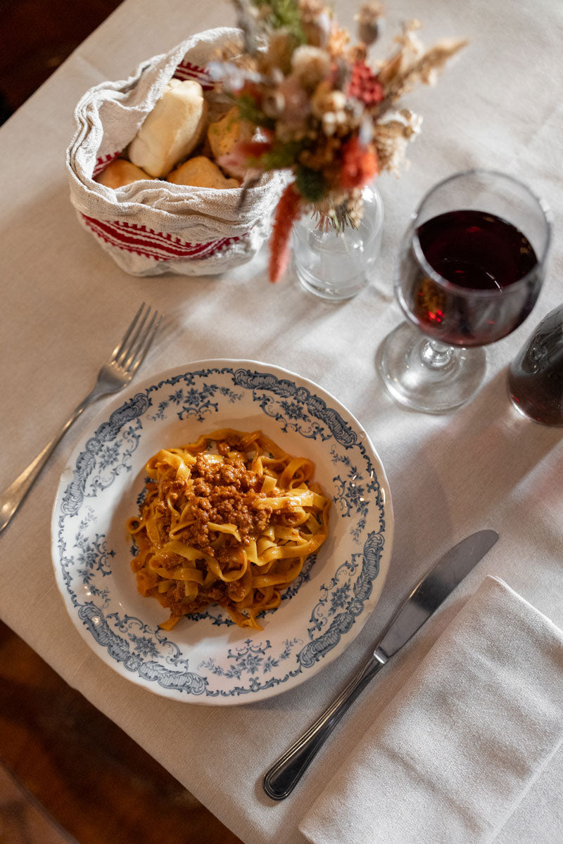 Tagliatelle with ragù and a glass of red wine at La Montanara