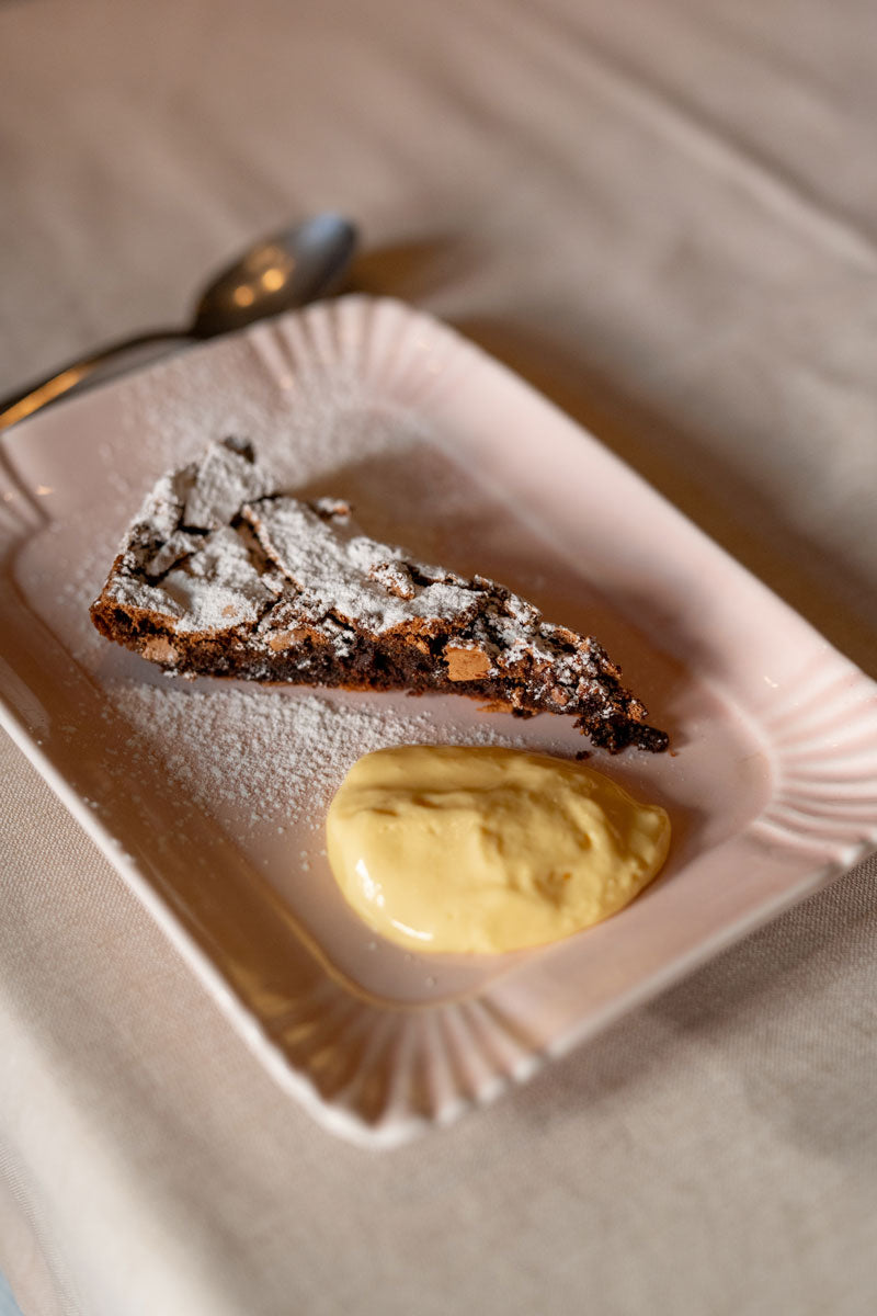 A slice of chocolate cake with cream at La Montanara