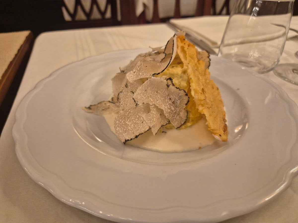 A porcini sformatino on Parmigiano cream with black truffle at Leonida