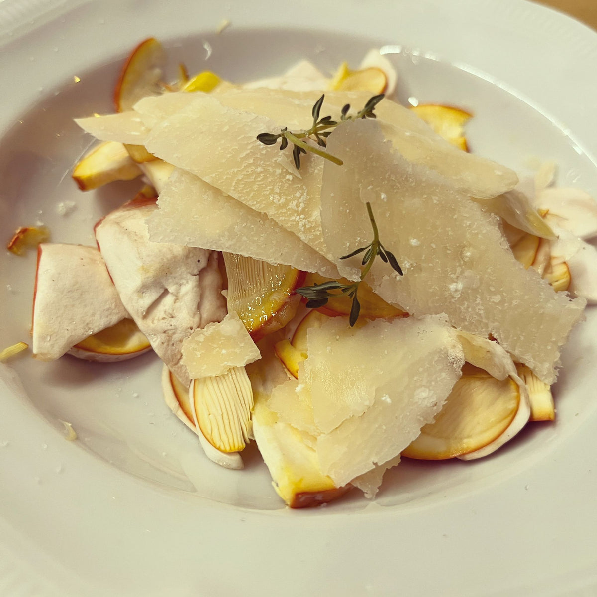 Thinly sliced mushrooms with shaved cheese and thyme at Osteria Bottega