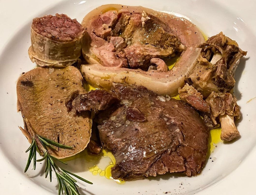 A plate of mixed roast meats with rosemary at Osteria Bottega