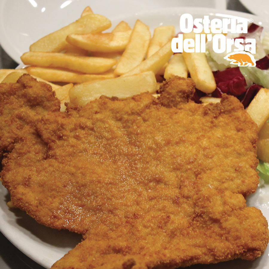 A breaded cutlet with fries and salad at Osteria dell'Orsa