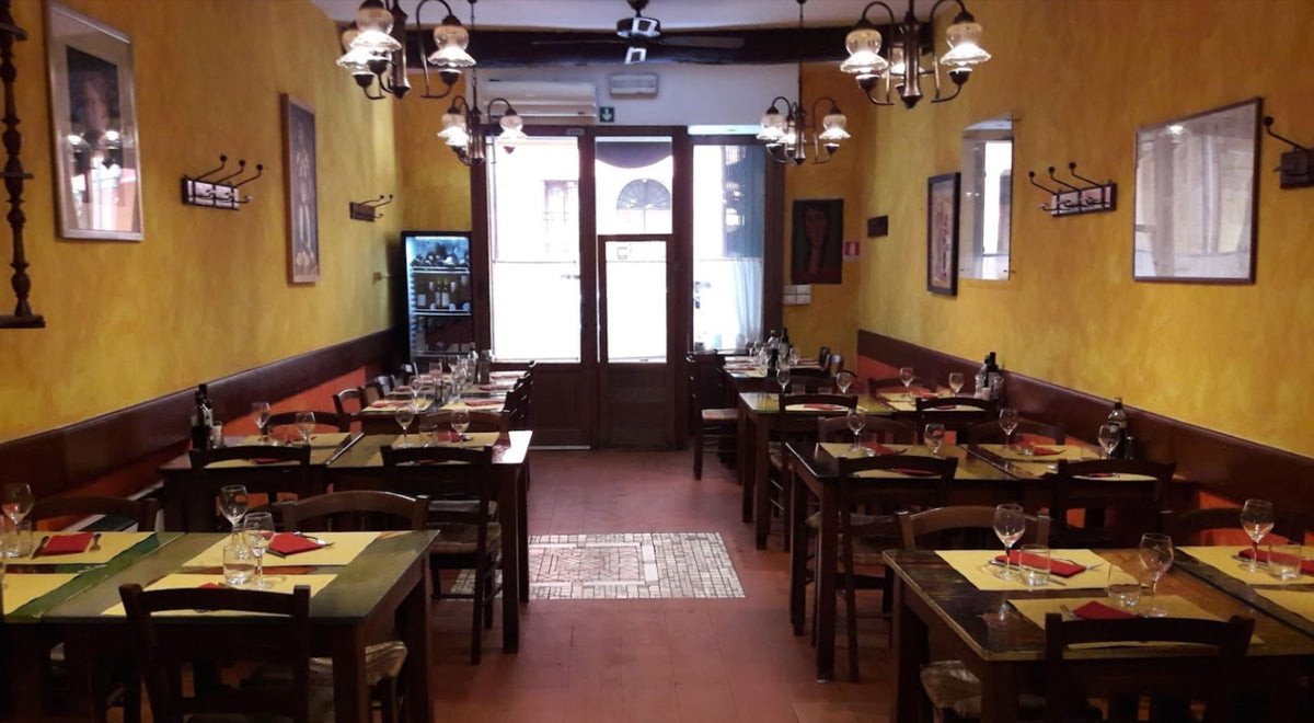 The dining room with tables set for service at Trattoria Trebbi