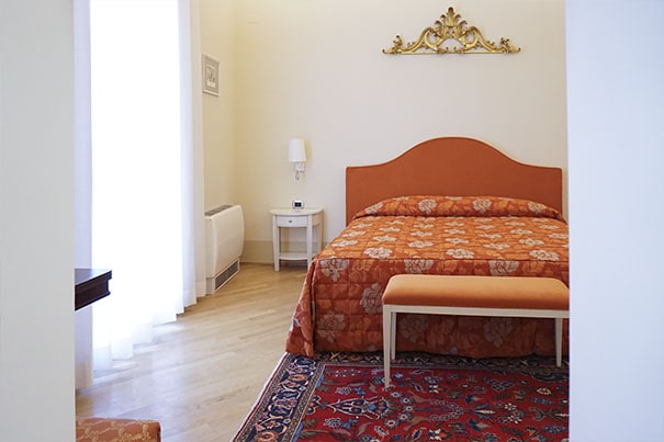 Double bed in the Bifora Room at Casa Isolani
