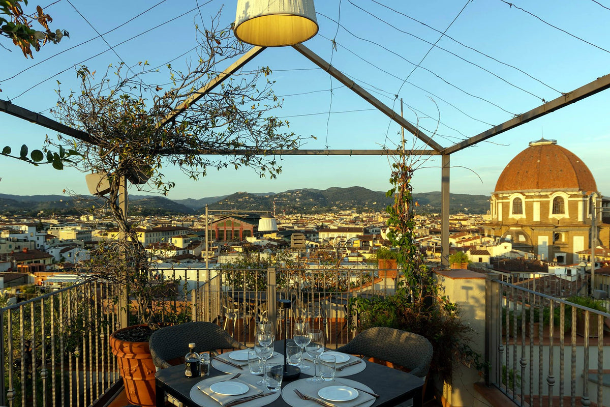 Rooftop terrace tables facing the Duomo dome at B-Roof Restaurant