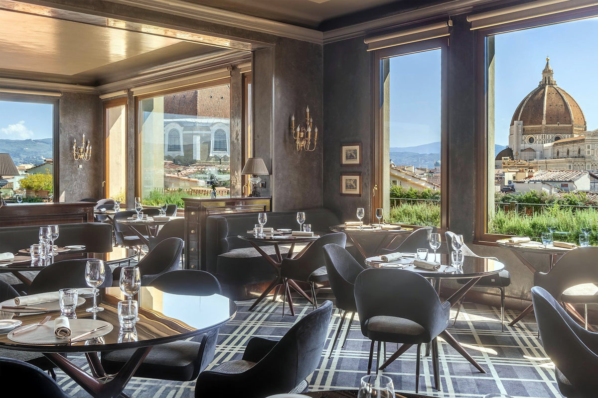 Indoor dining room with windows onto the Duomo at B-Roof Restaurant