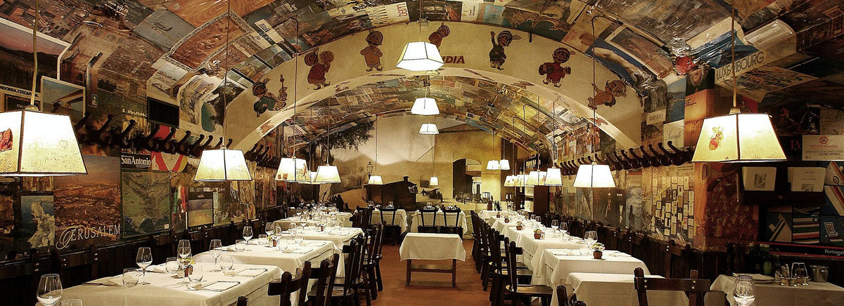 Vaulted dining room with poster-covered walls at Buca Lapi