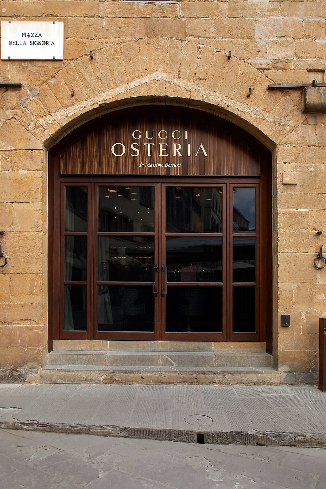 Arched wooden entrance of Gucci Osteria da Massimo Bottura