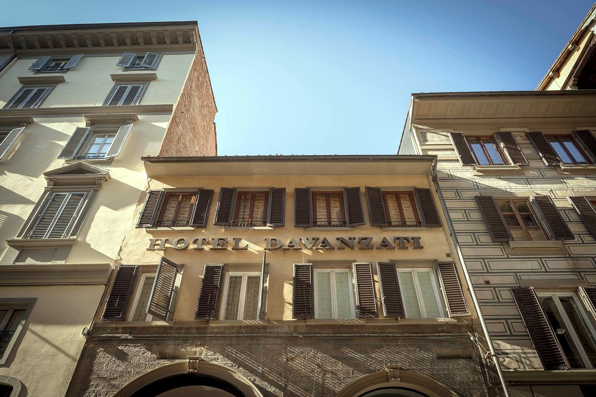 Façade of Hotel Davanzati with green shutters and lettered sign
