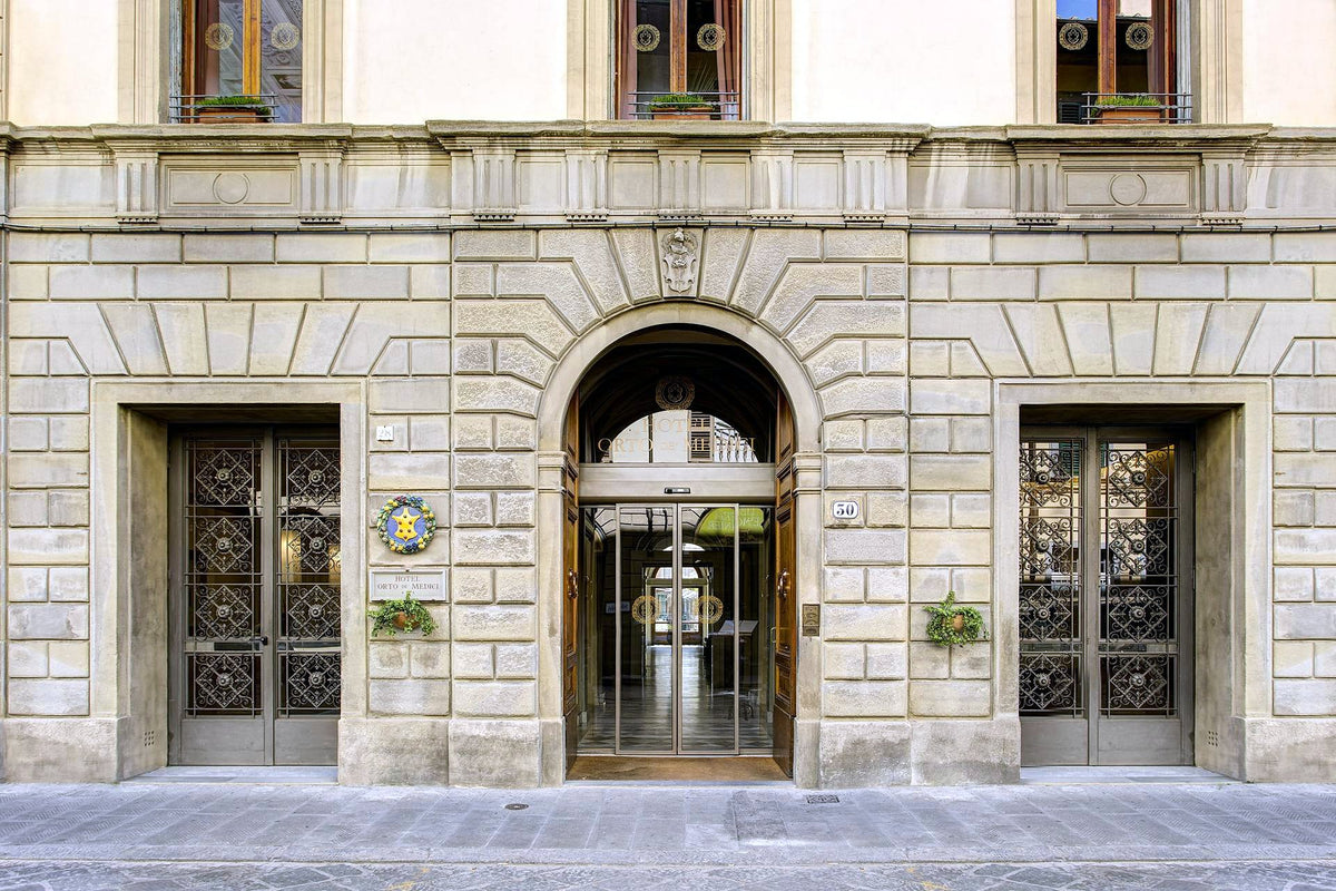 Stone façade and arched entrance of Hotel Orto de' Medici