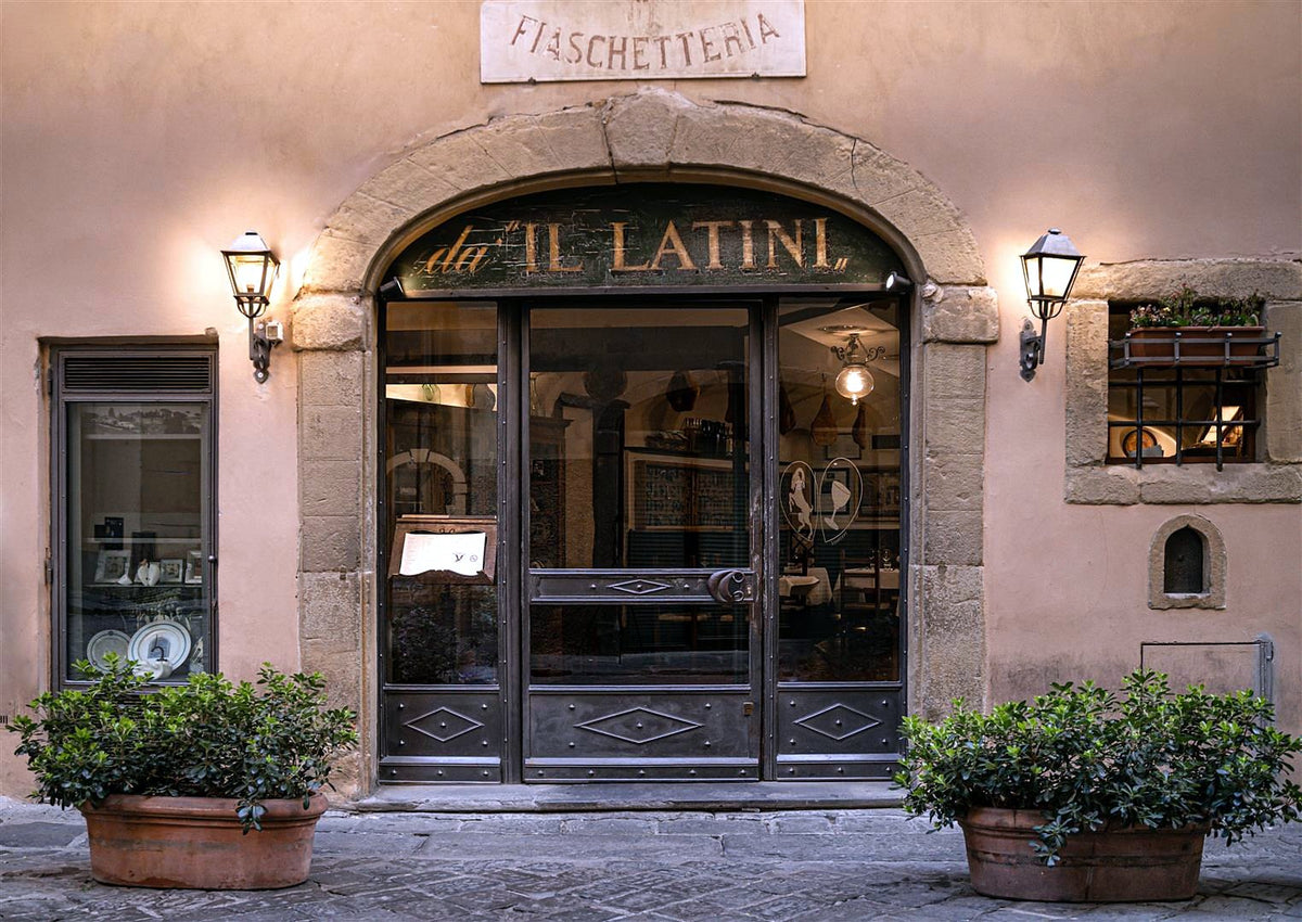 Arched entrance of Il Latini on a Florence street