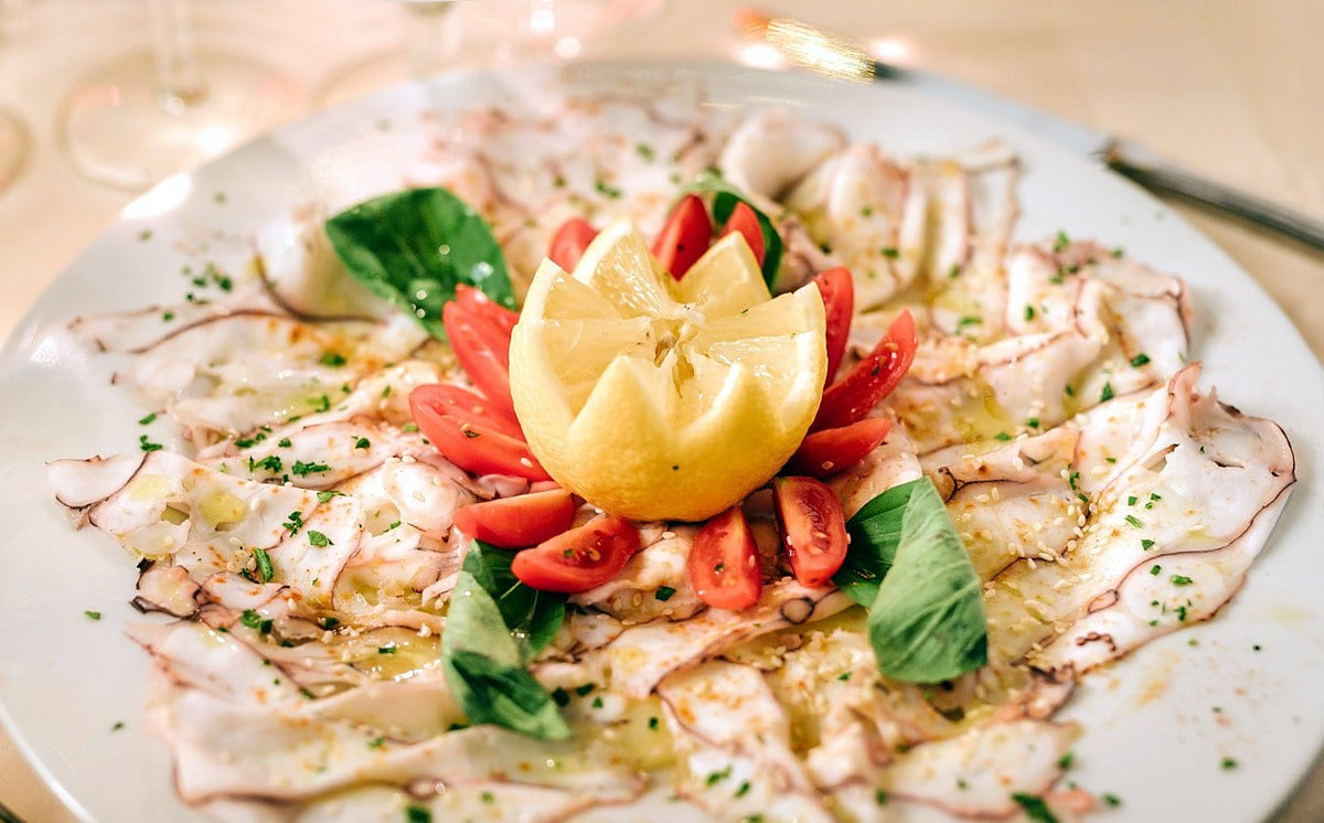 Thinly sliced carpaccio with tomatoes and basil at La Giostra