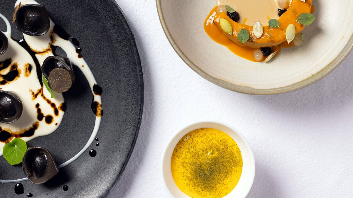 Plated courses on white linen at La Leggenda dei Frati