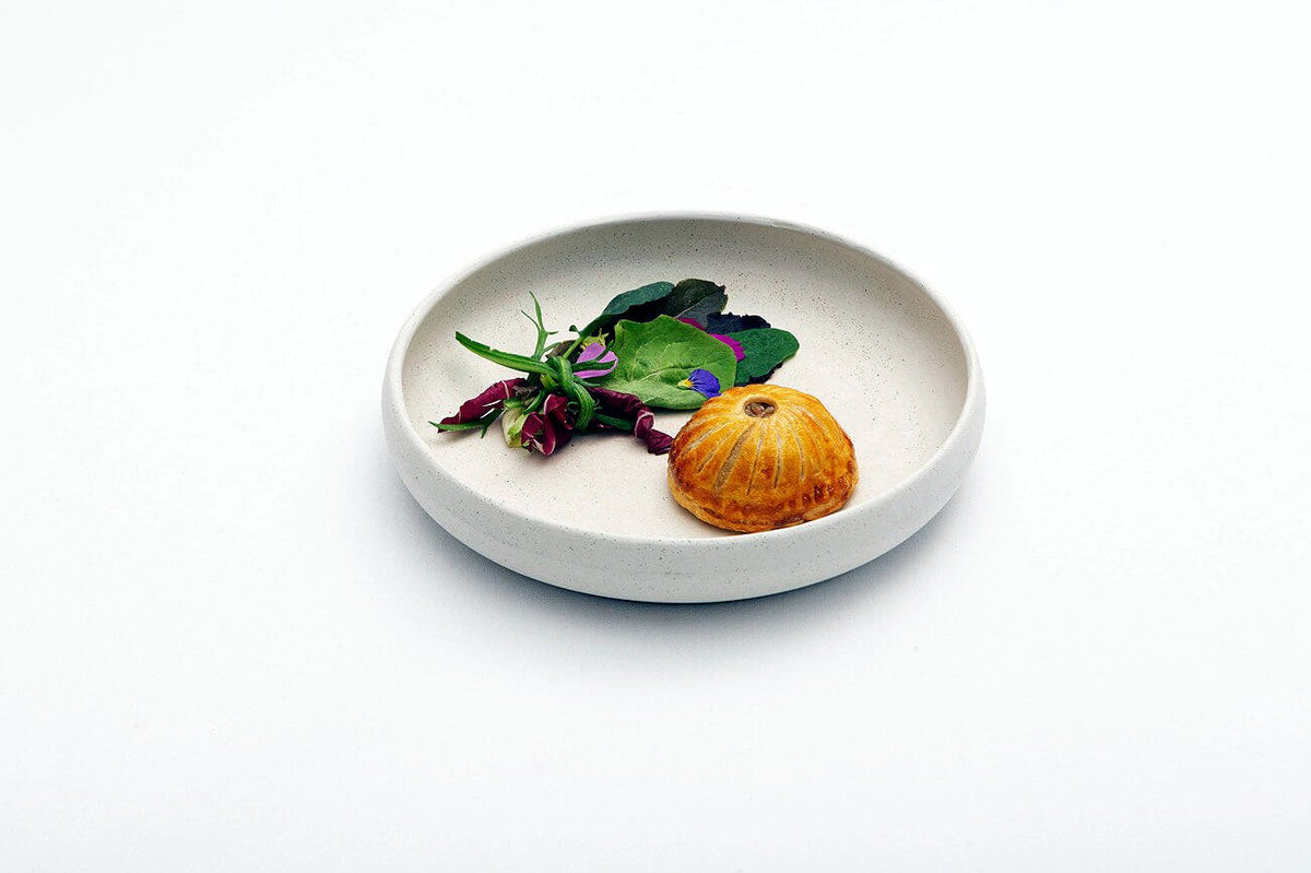 A plated course with herbs at La Leggenda dei Frati
