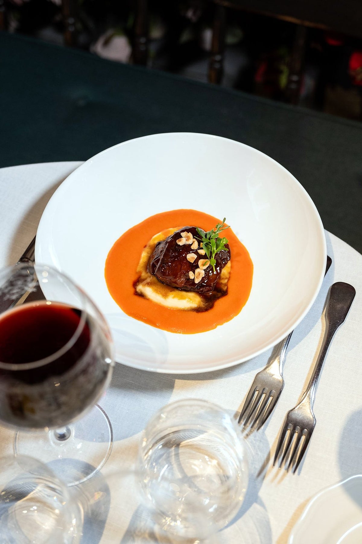 Plated meat on orange sauce with red wine at La Ménagère
