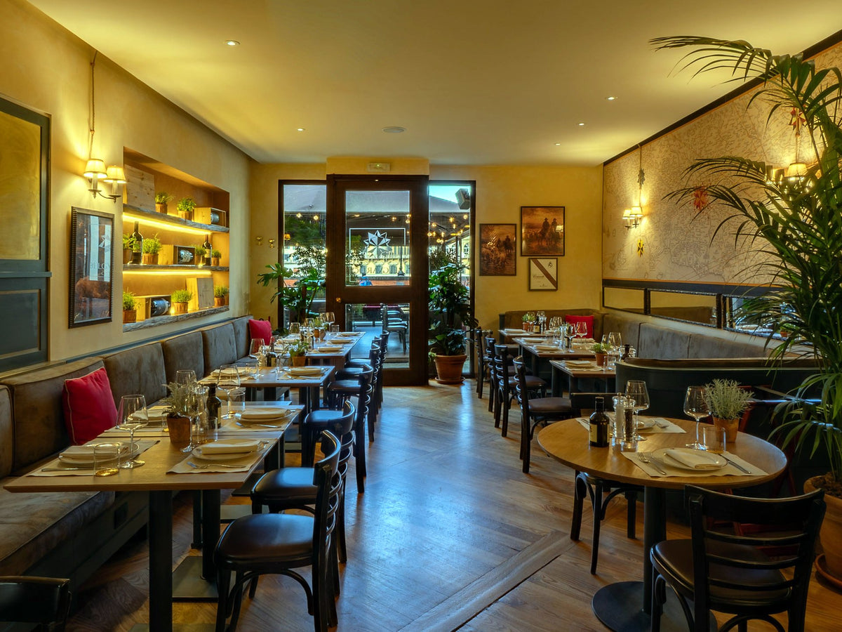 Dining room with banquettes and wine niches at Osteria Belguardo