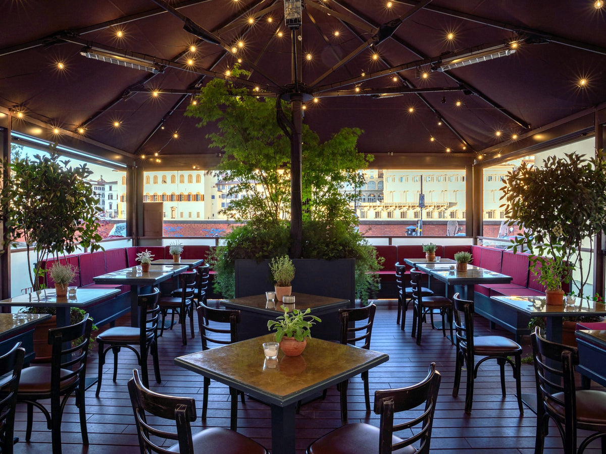 Covered terrace with set tables at Osteria Belguardo