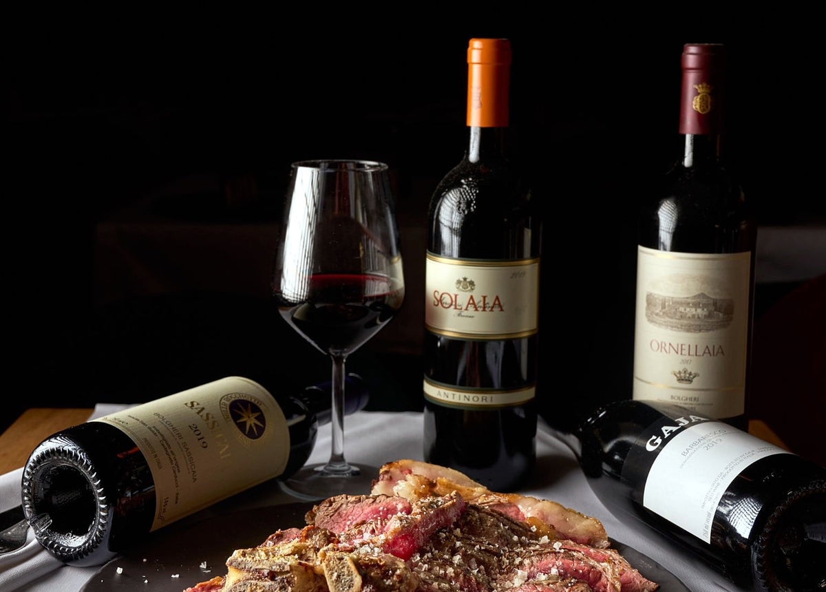 Tuscan red wines with sliced steak at Osteria Belle Donne