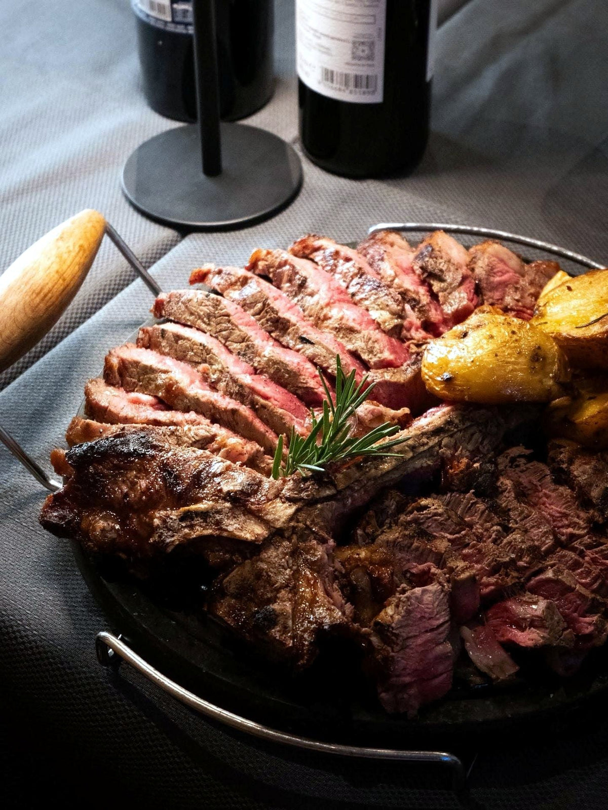 Sliced bistecca alla fiorentina with potatoes at Osteria dell'OK