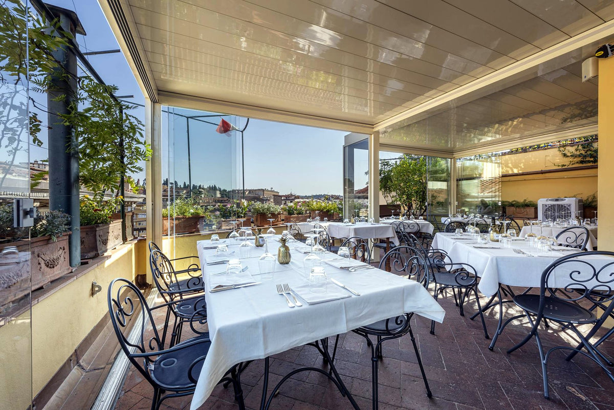Covered terrace with laid tables at Osteria delle Tre Panche
