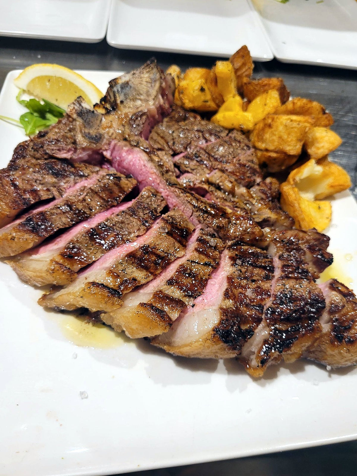 Sliced grilled steak with roast potatoes at Ristorante La Spada
