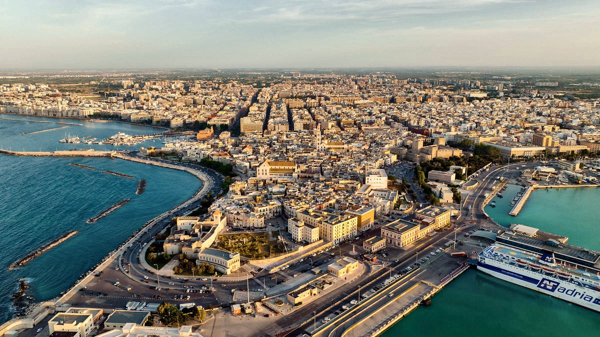 Bari from above in late light, the old town on its peninsula between two harbours