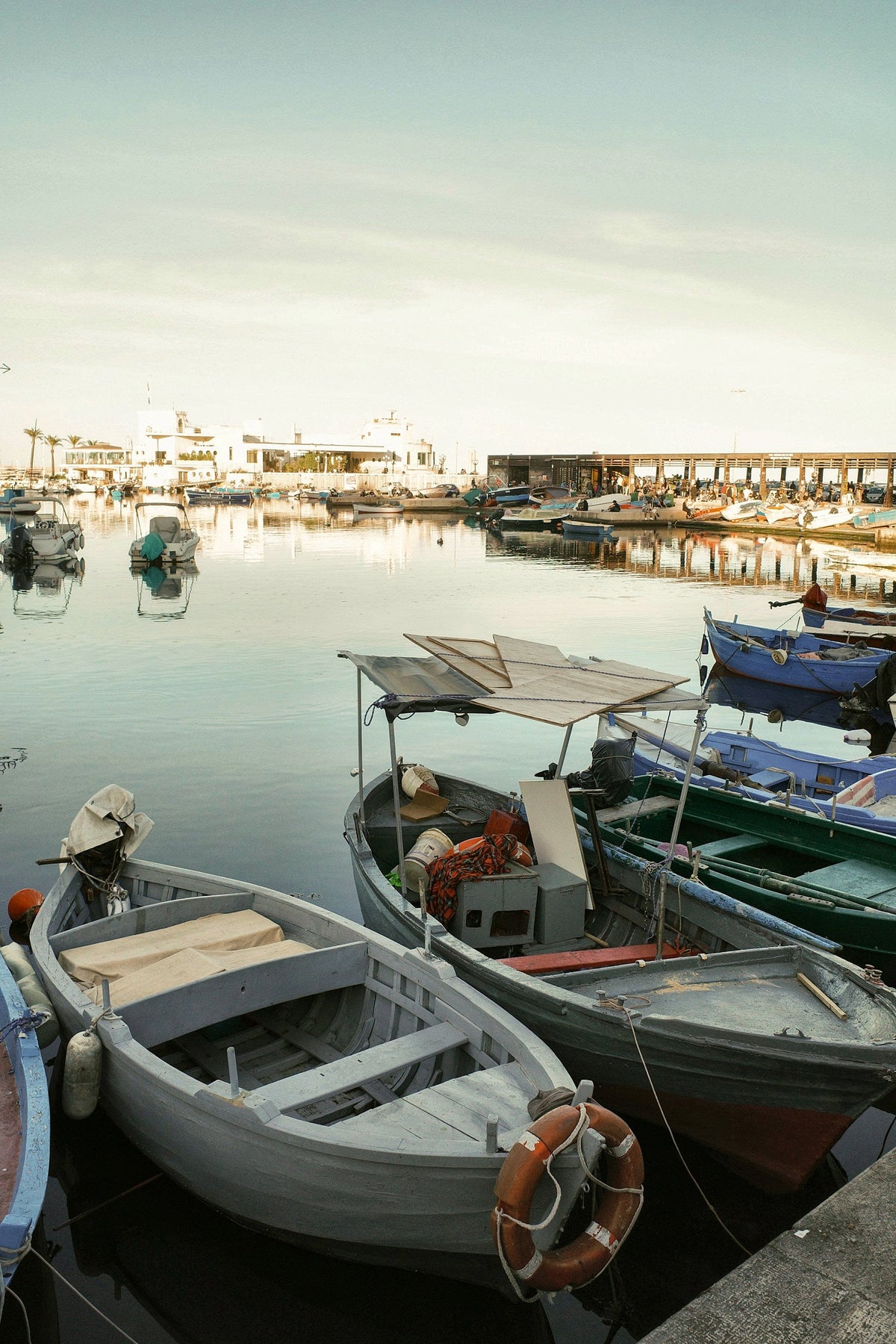 Small boats in the harbour in warm low light