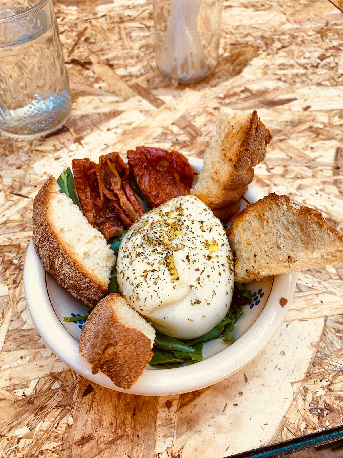 Burrata with sun-dried tomatoes and bread, a Puglia classic