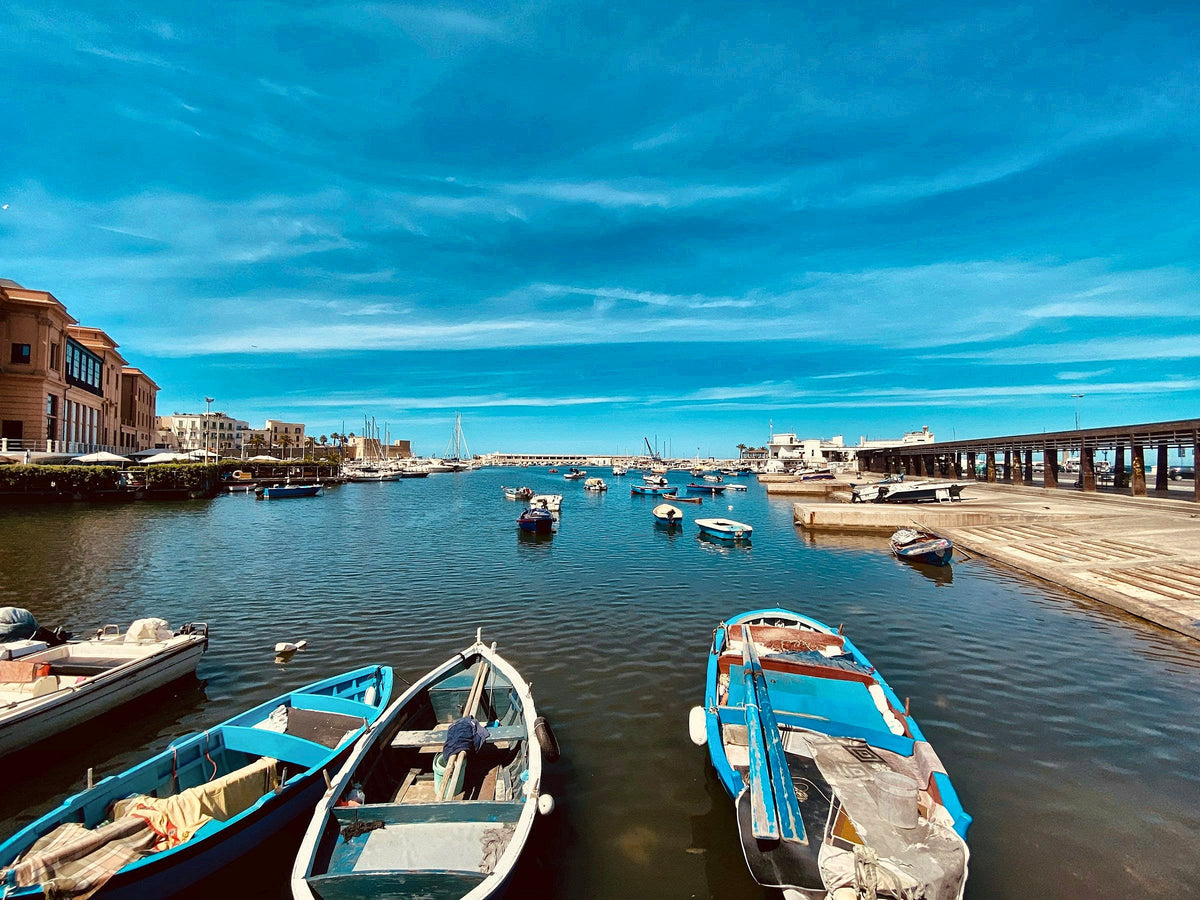 Wooden fishing boats moored in the old port of Bari