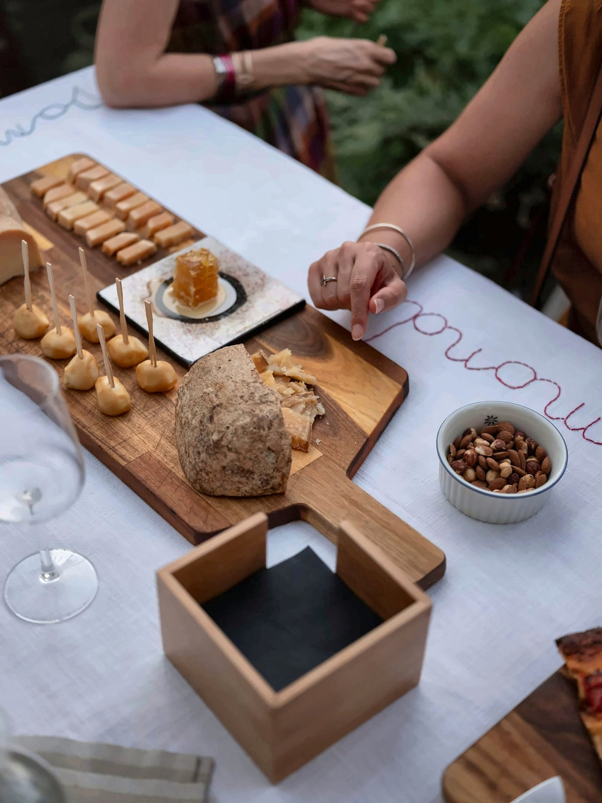 Bread, biscuits and nuts served on a wooden board at the Imago+ bistrot